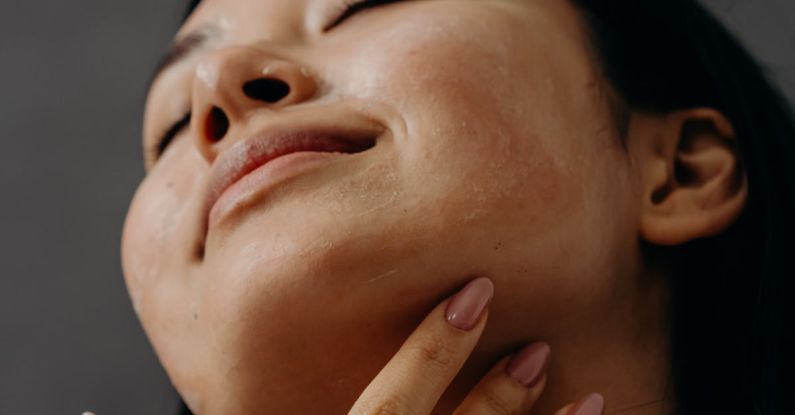 Exfoliants - A Woman Touching Her Neck with Her Eyes Closed