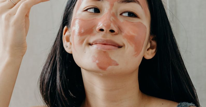 Exfoliation - A Woman in Gray Tank Top Doing Her Skin Care