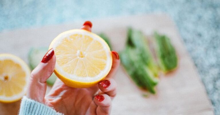 Vitamin C - Selective Focus Photography of Person Holding Sliced Lemon