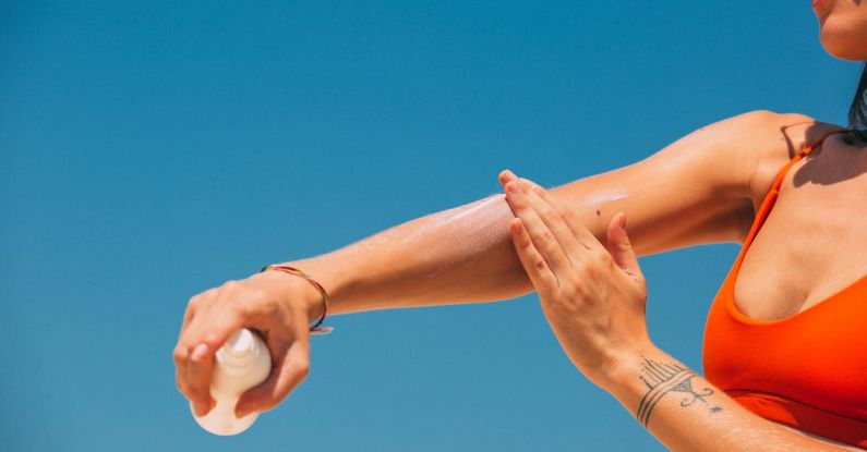 Sunscreens - A Woman Applying Sunscreen on Arm