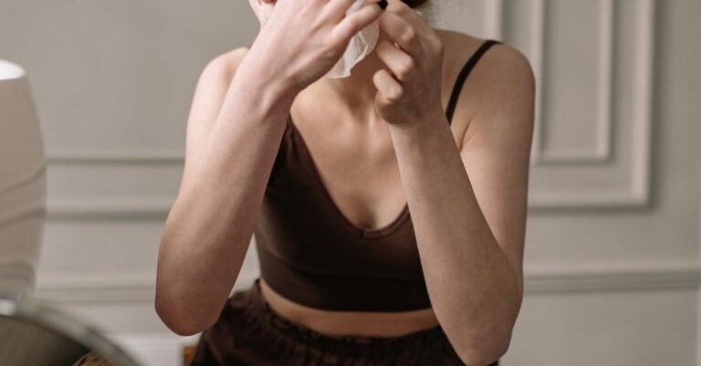 Anti-Aging - A Red-Haired Woman Putting a Facial Mask