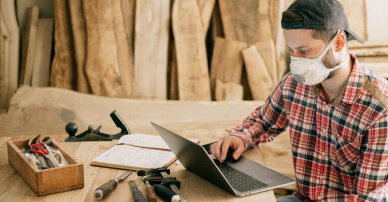 Masks - Man Using a Laptop at a Wood Workshop