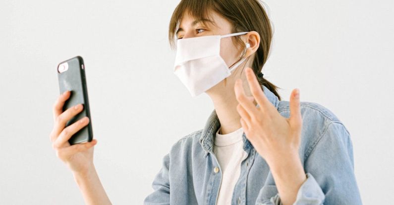 Masks - Woman With a Face Mask having a Video Call