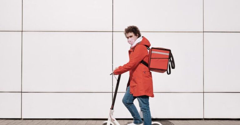 Masks - Delivery Man Wearing a Face Mask and Riding a Scooter